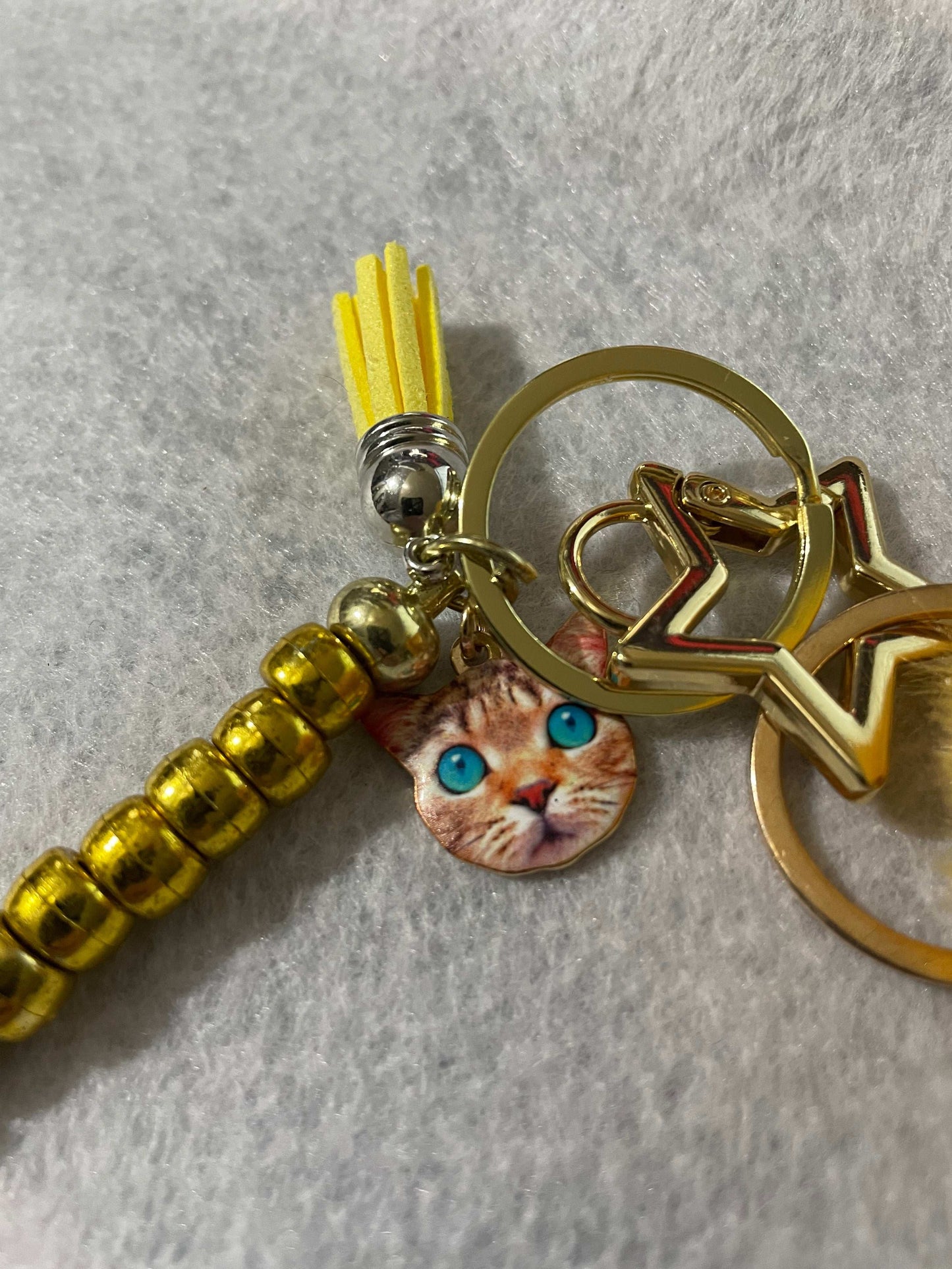Cold Cat Keychain with beads and pom pom close up