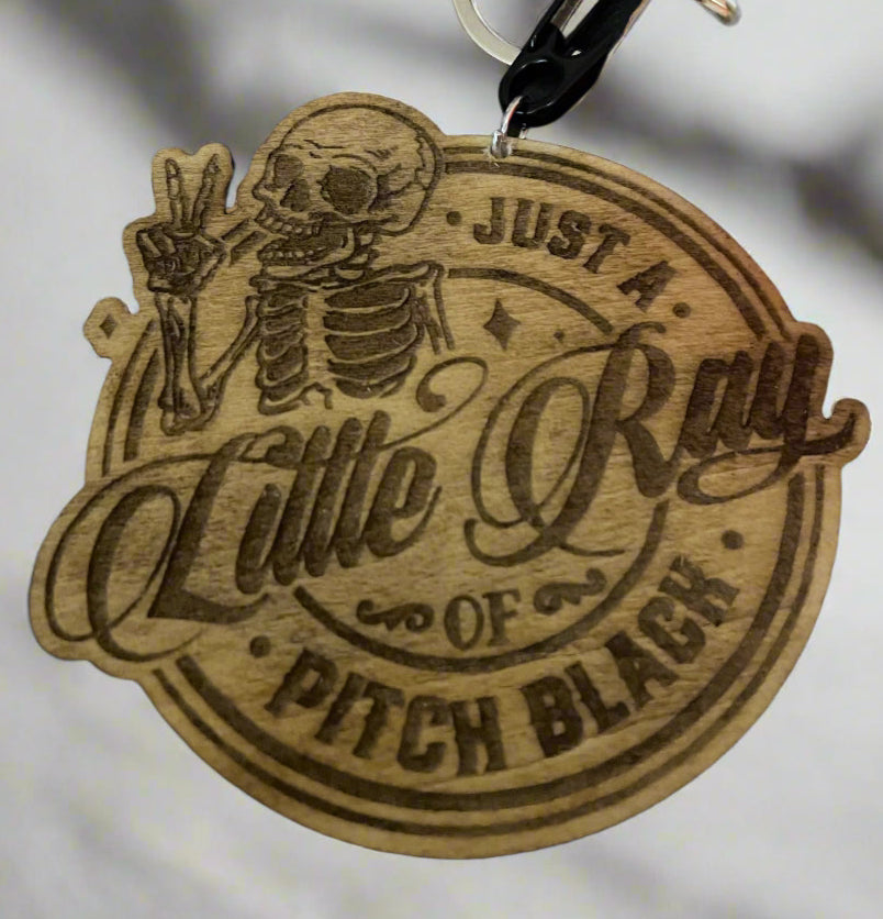 Little Ray of Pitch Black wooden keychain close up