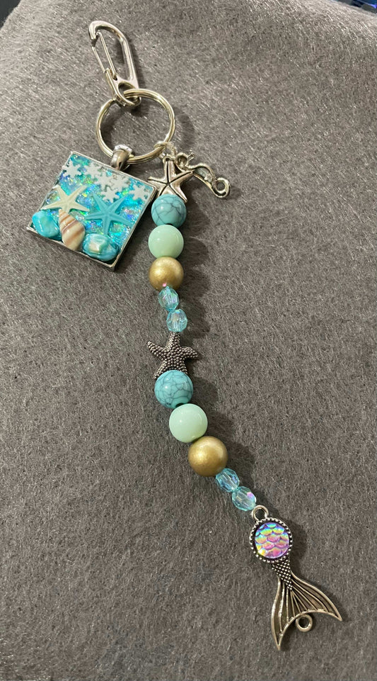 Ocean themed resin pendant with charms and resin ocean pendant
