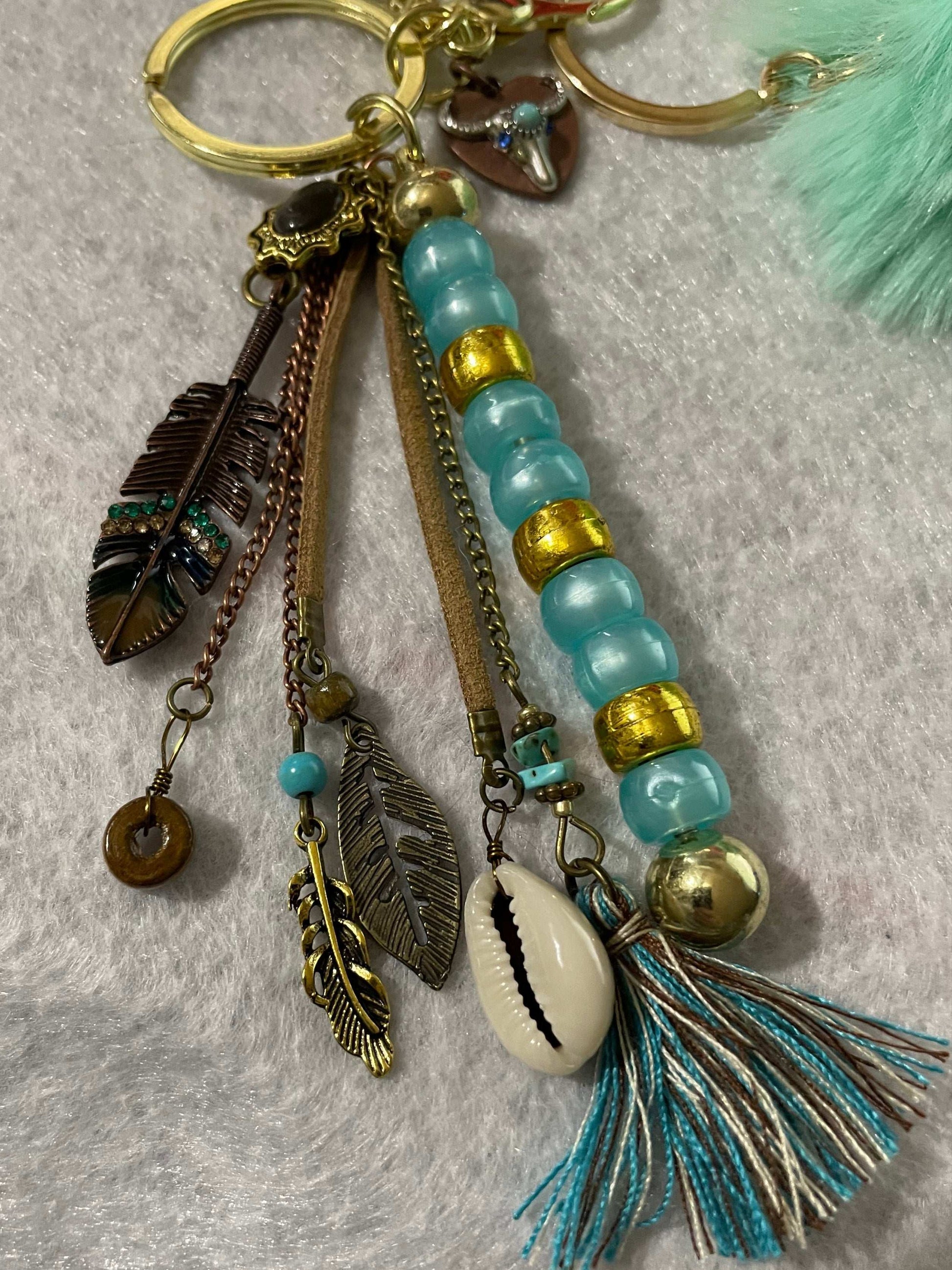 Western keychain close up of feathers and seashell