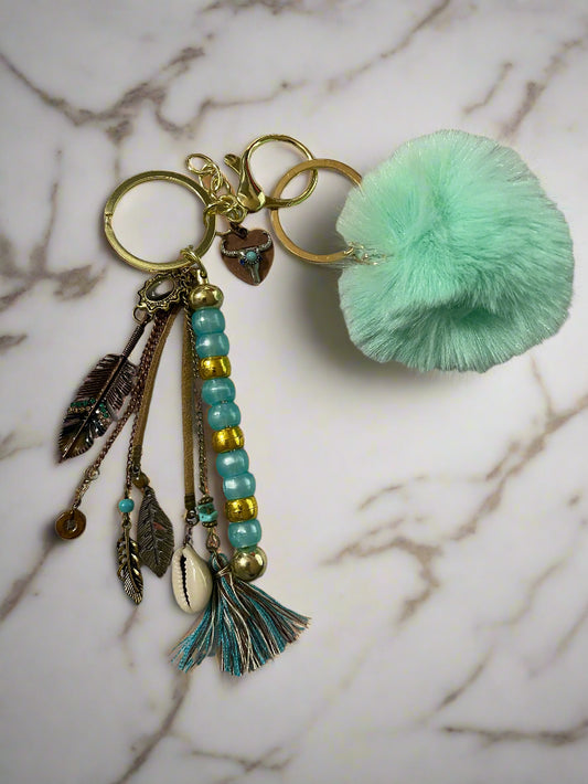 Western keychain with feathers and bull horns top view